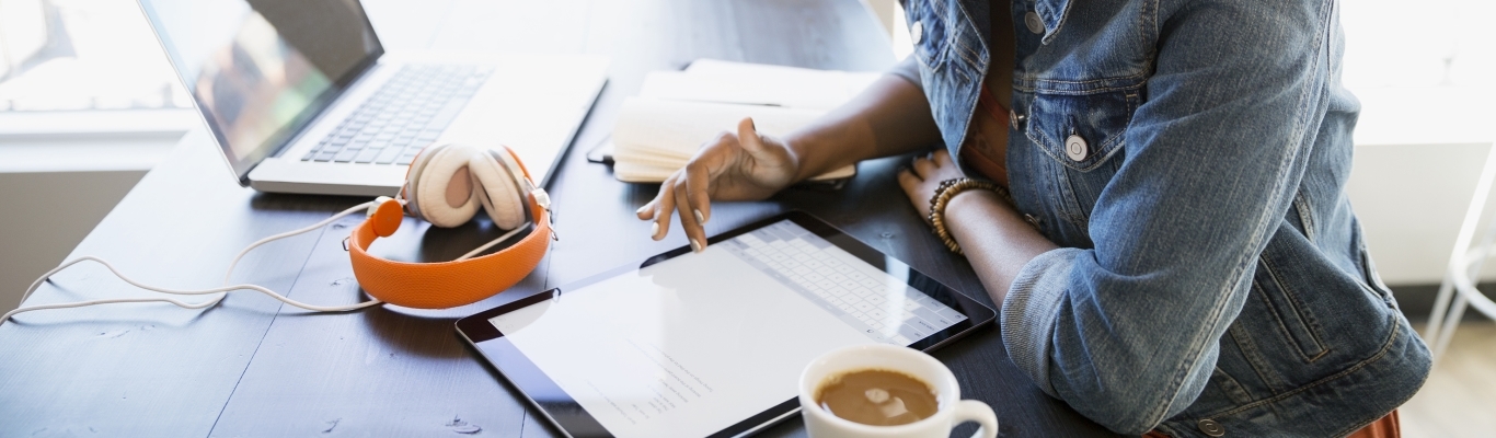 Woman looking at tablet in coffee shop